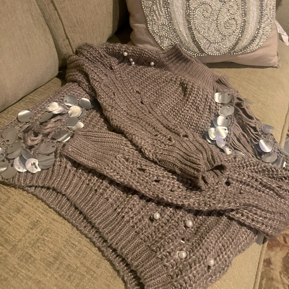 Distressed sweater with sequins and pearls attached
